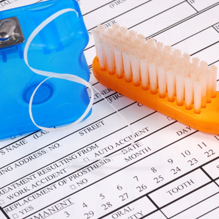 toothbrush and floss on an insurance form